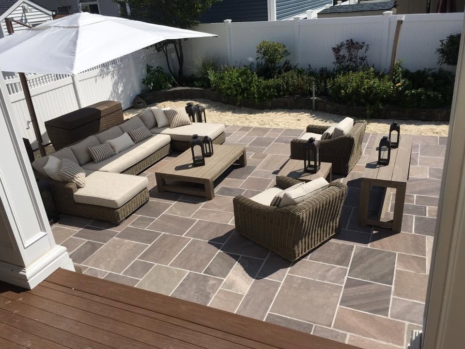 Outdoor patio with bluestone pavers, sectional seating and pergola