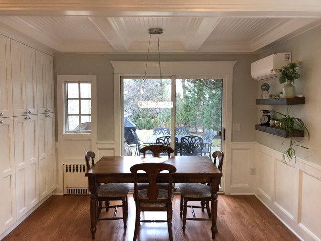 Dining room with beadboard ceiling, wainscoting and sliding glass doors to patio